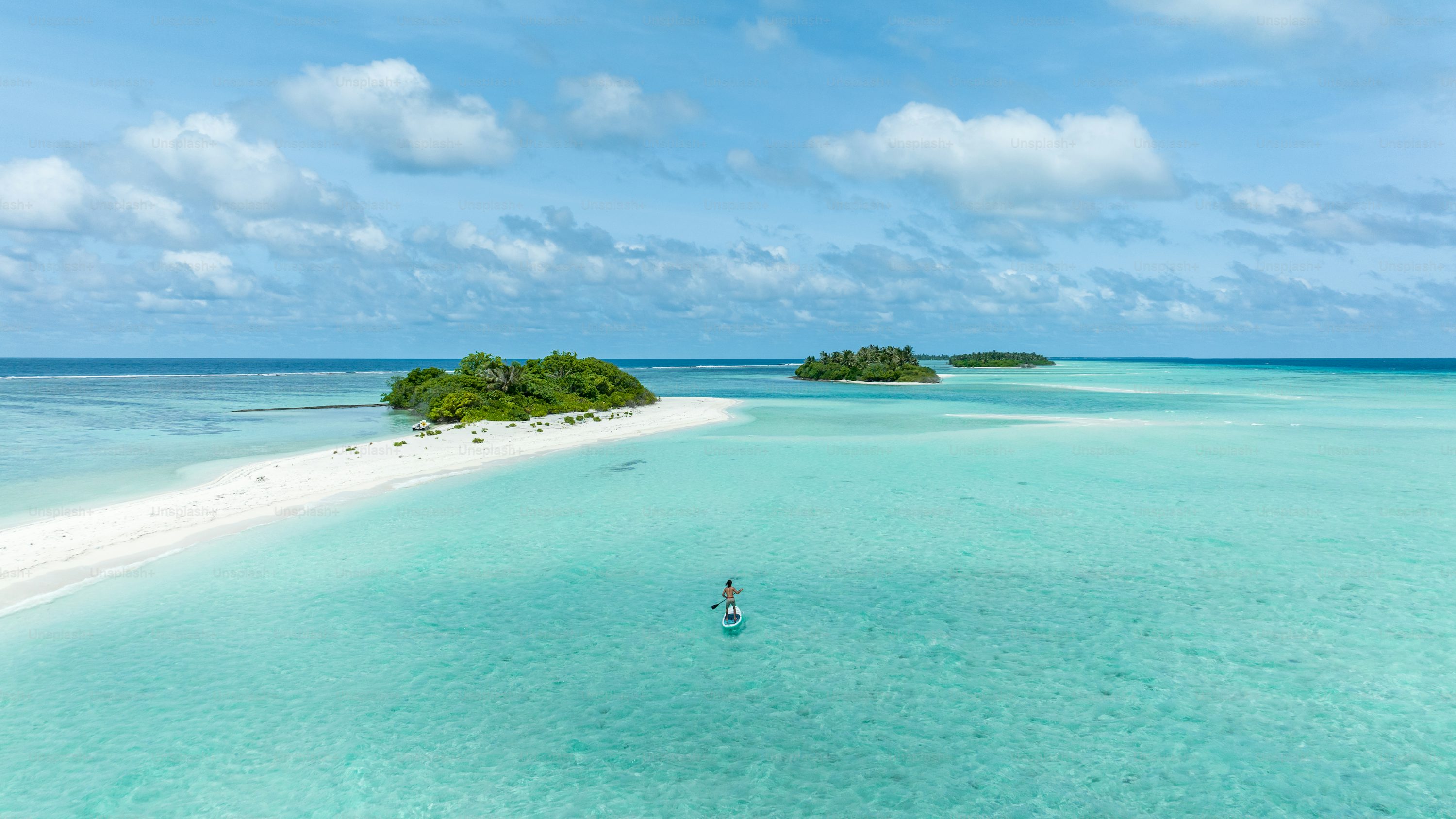 Young traveler standing on a pristine sandbank in the Maldives