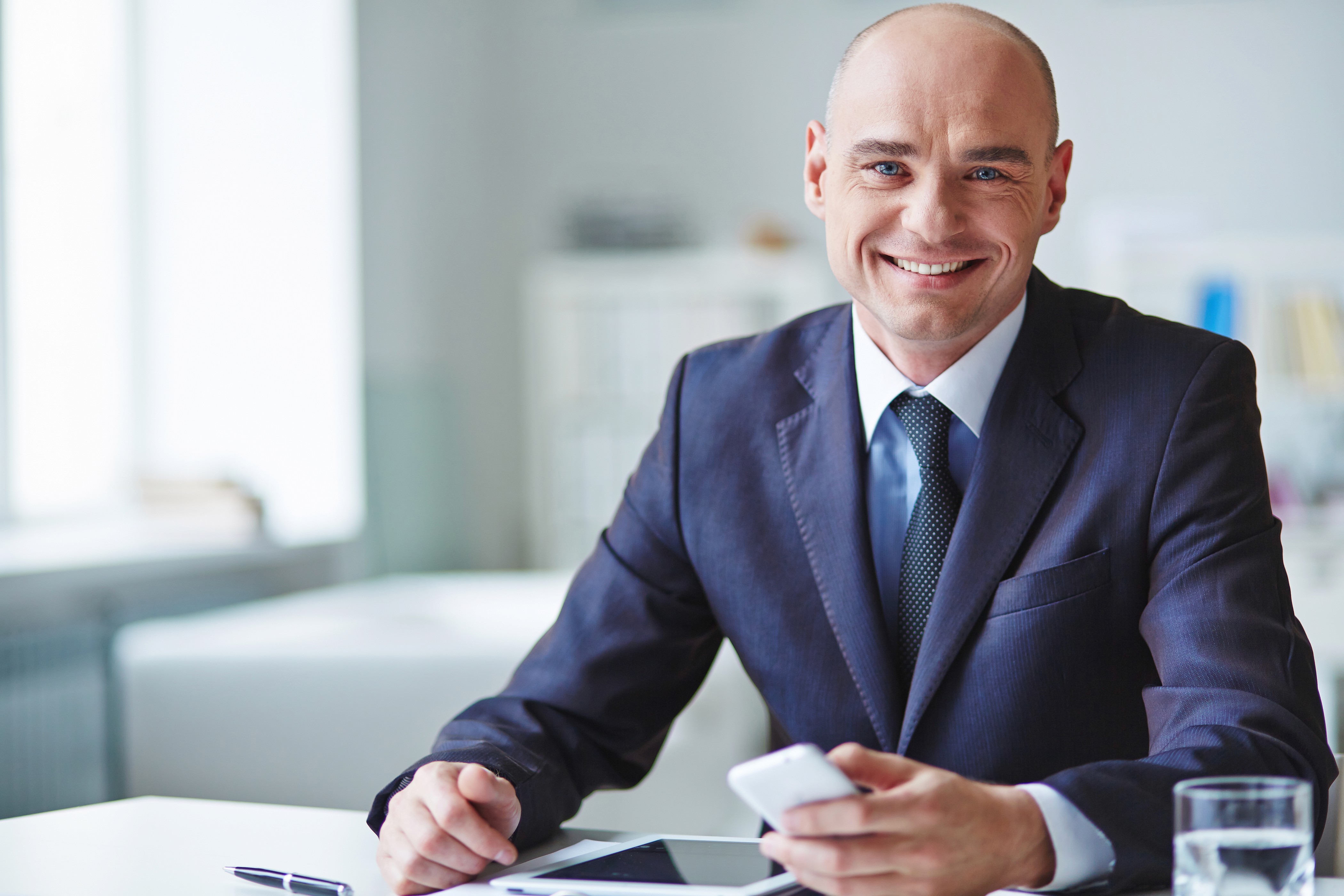Manufacturing executive reviewing reporting systems and analytics for manufacturing marketing and digital marketing for manufacturers.