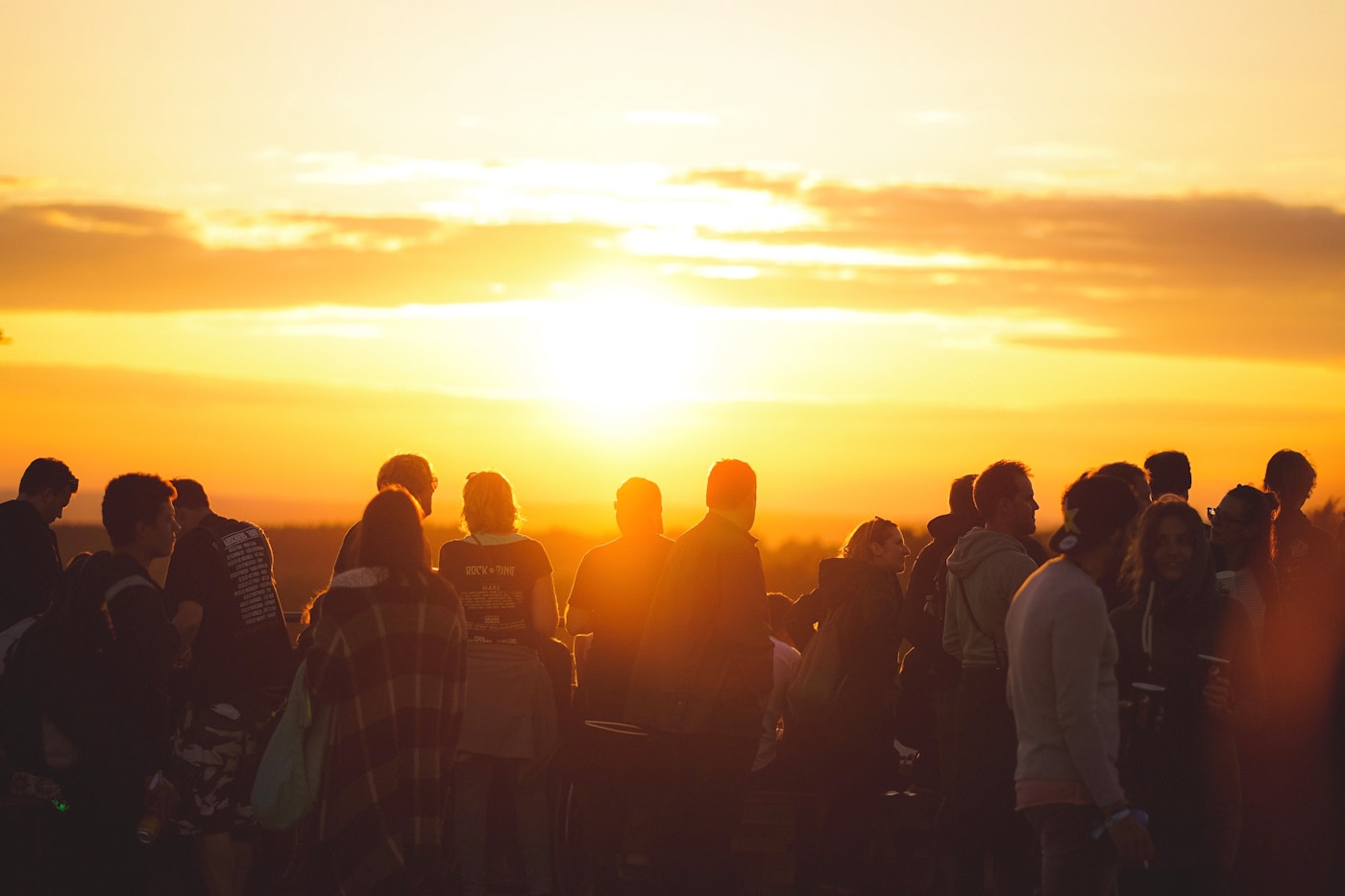 Stylish people at a rooftop social event during sunset