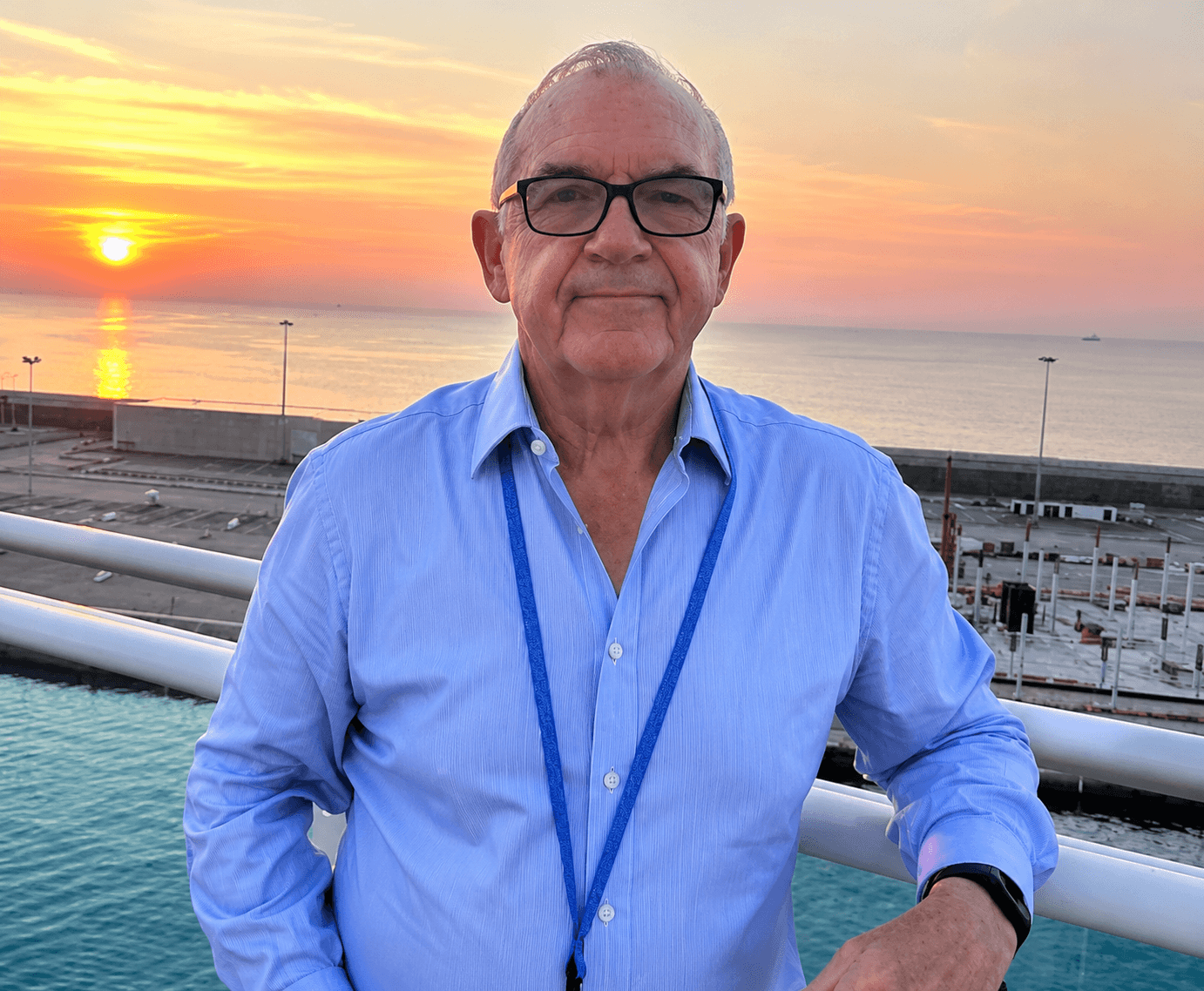 David Wortley on a cruise ship deck at sunset, reflecting global speaking and immersive learning experiences.