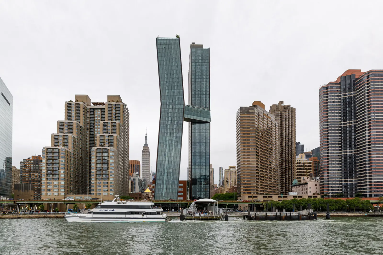 New York City skyline with unique H-shaped skyscraper and water