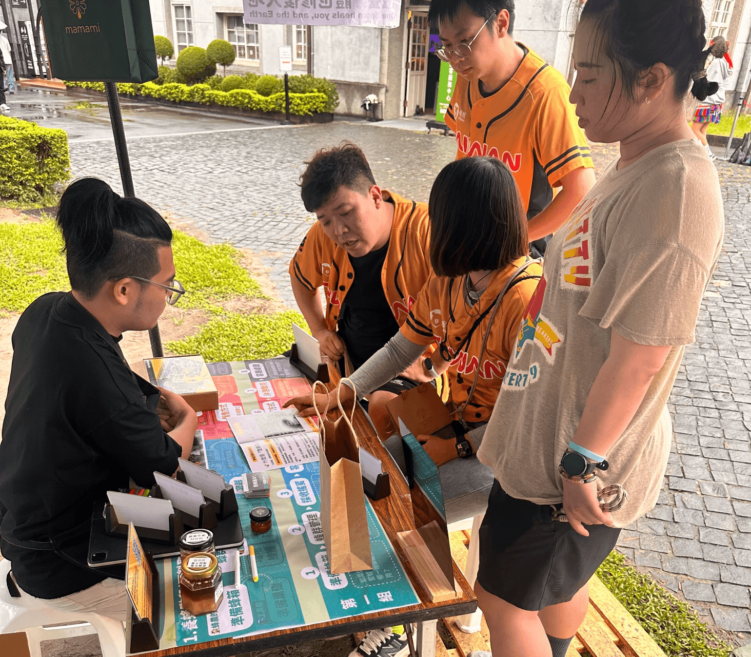 A man stading with Surfboard