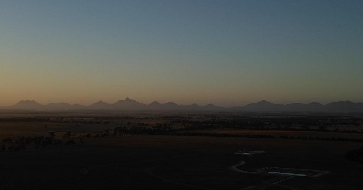 Sunrise breaking over distant mountains, symbolizing the hopeful future of personal finance.