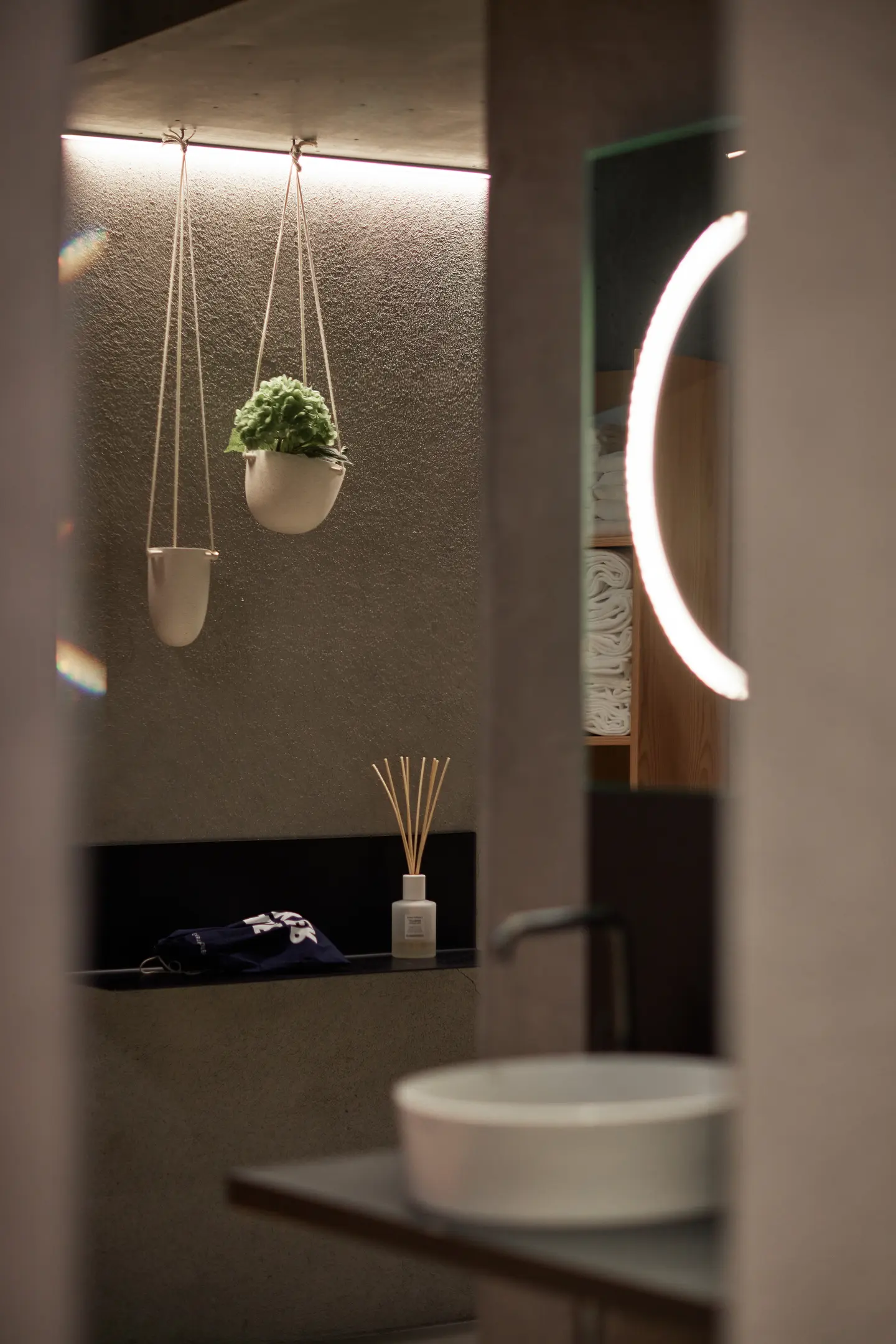 Tiled sauna shower area with a person seen behind translucent glass