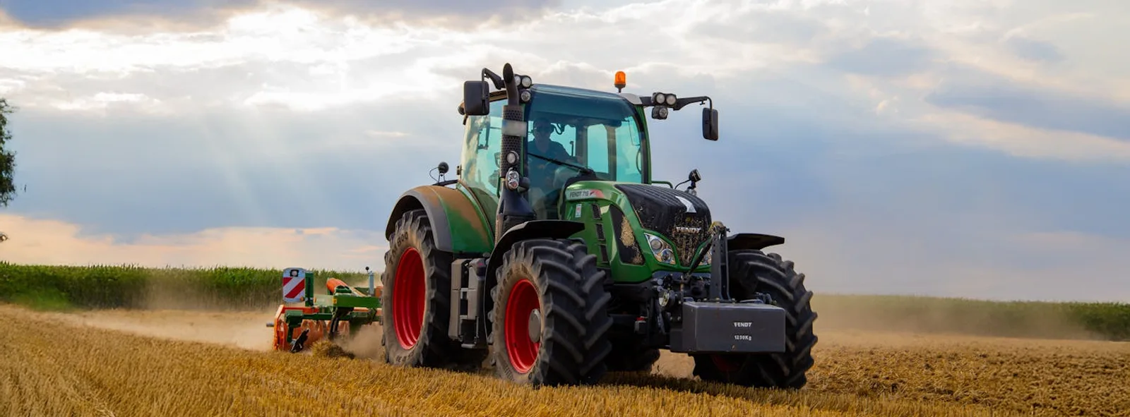 a farmer operating a tractor in a field