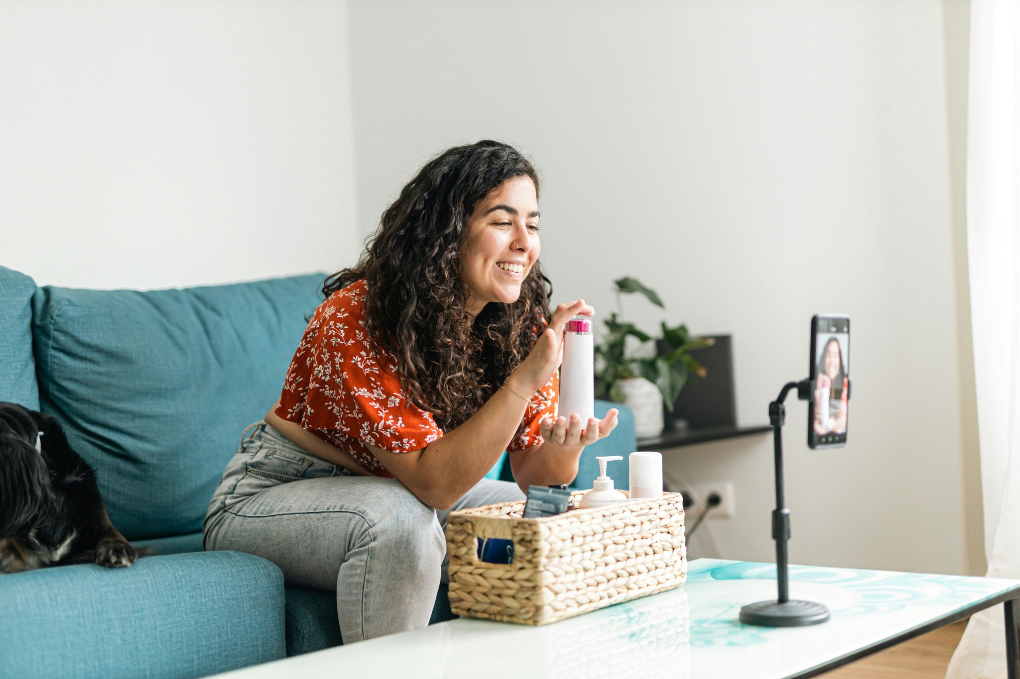 Woman showcasing products in video recording for online studio