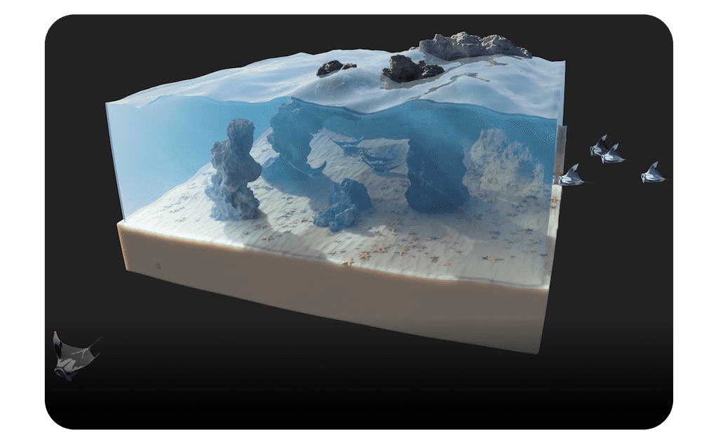 3D-rendered diorama of an underwater coral reef environment with clear water, rocky formations, sandy ocean floor, and swimming fish.