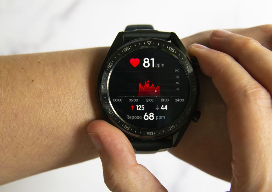 a woman squatting on the floor in a gym