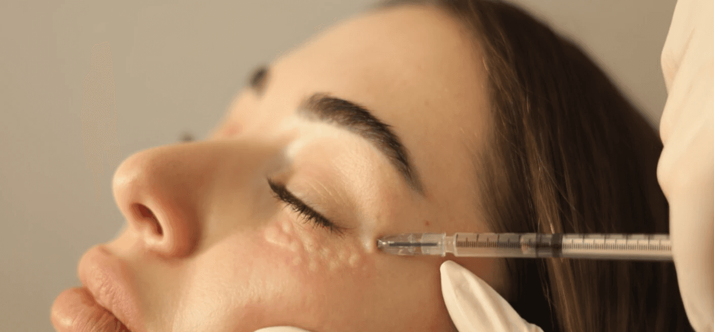 Een houten essentiële olieverstøviger die een zachte mist verspreidt, omringd door kleine flesjes essentiële oliën en gedroogde kruiden. De zachte verlichting versterkt de gezellige en therapeutische sfeer.