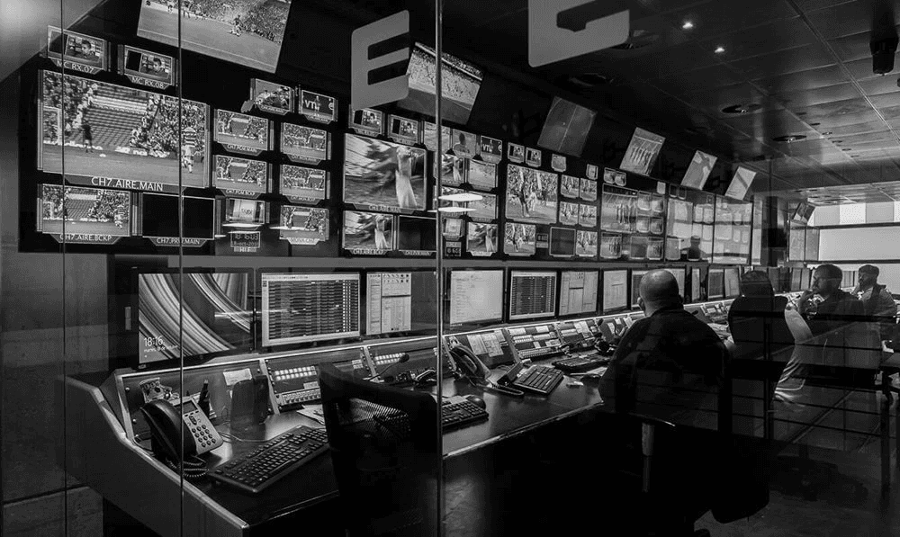 A professional studio with more than 30 screens, with 4 people working.