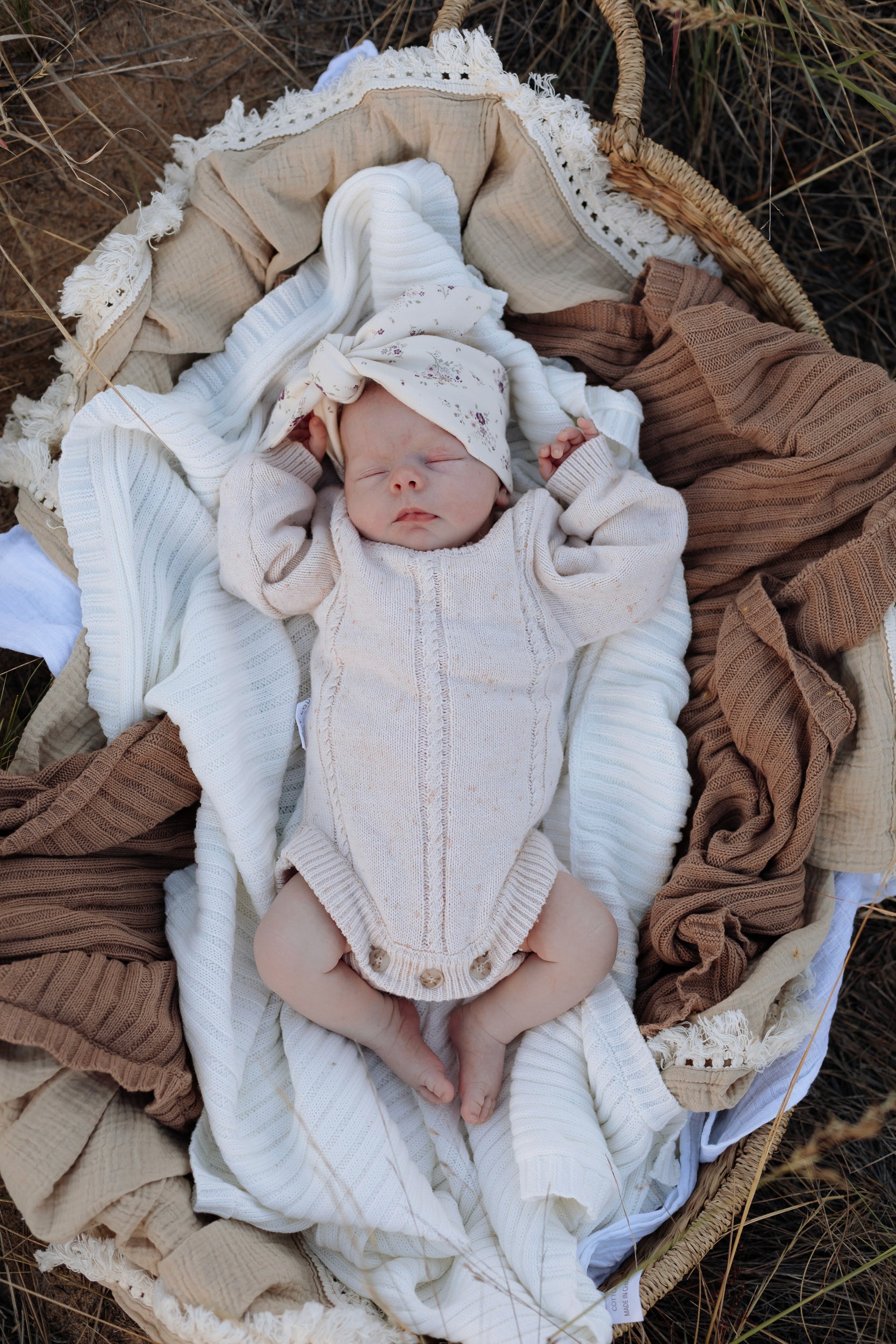Newborn baby sleeping in basket in outdoor newborn photoshoot in Mackay