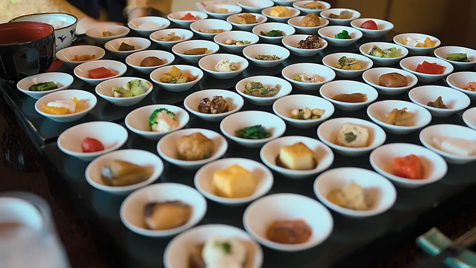 Massed small dishes at a Kurokawa Onsen café, shallow depth of field