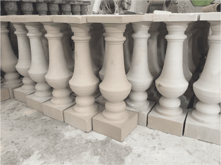 Multiple finished stone balusters crafted by the Bridge-type Bidirectional Cuts Machine, ready for installation in architectural projects.