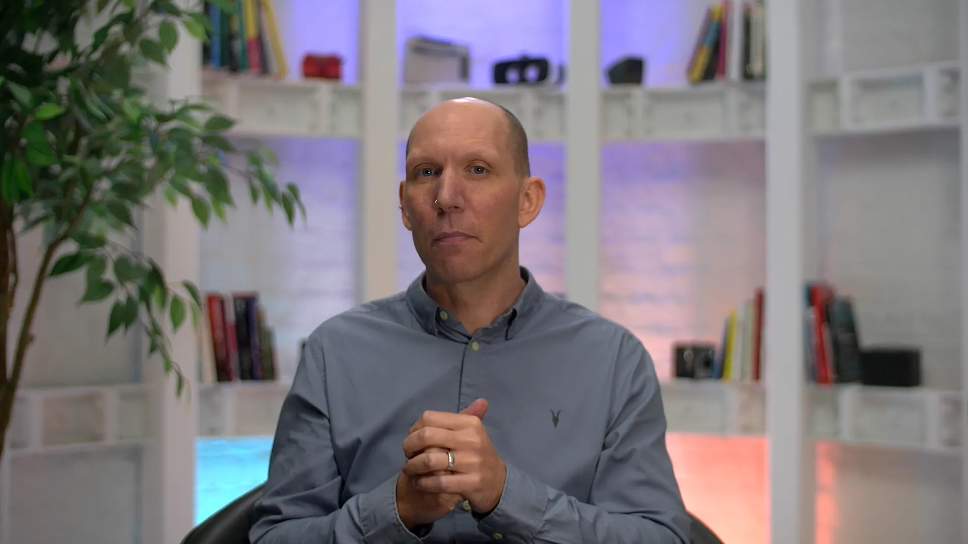 Owen Vittanuova, Managing Director at Paradigm, seated in a studio setting and speaking to camera during an AI presenter cloning experiment, filmed with soft studio lighting and a calm, professional backdrop.