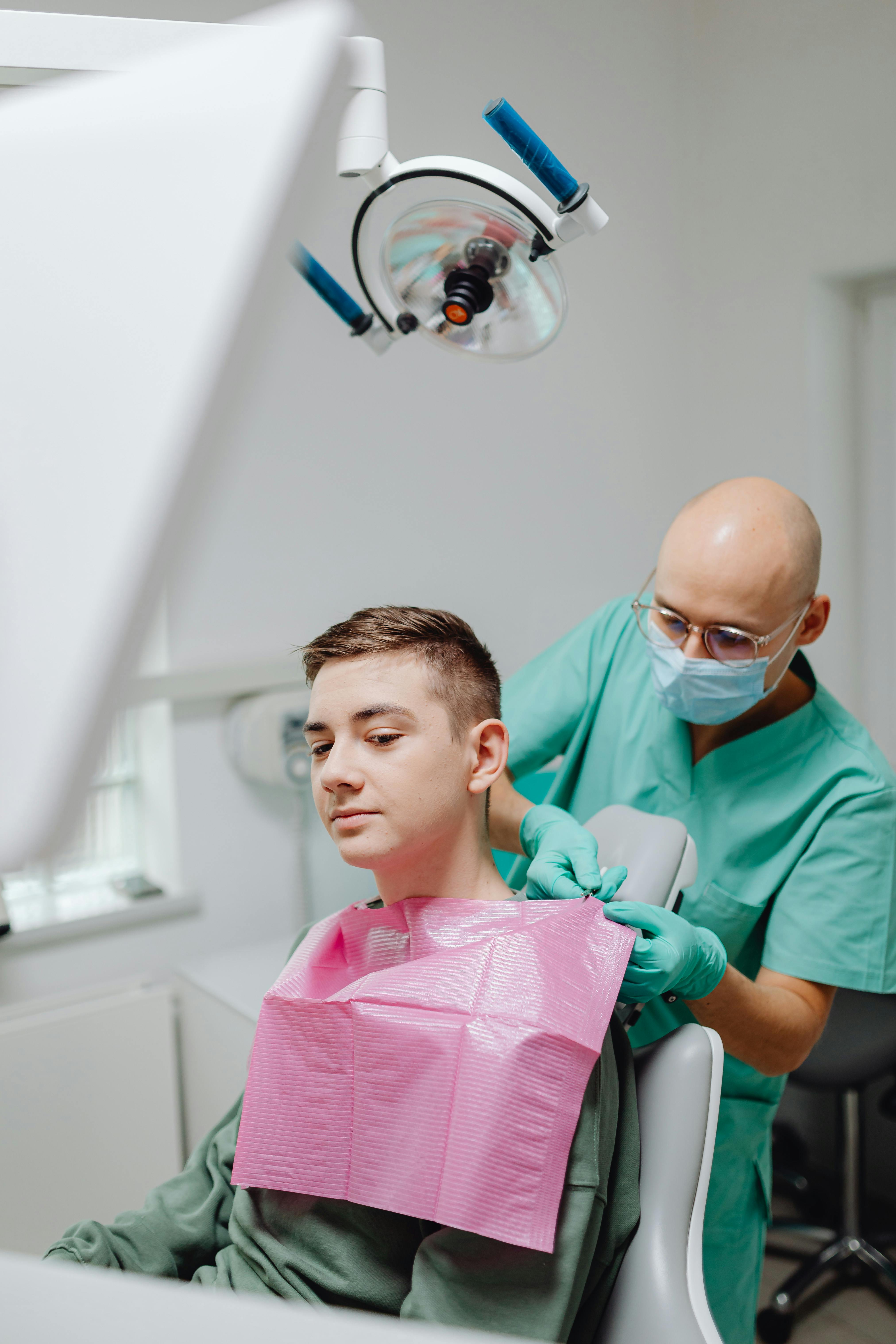 man in white dress shirt holding black pen