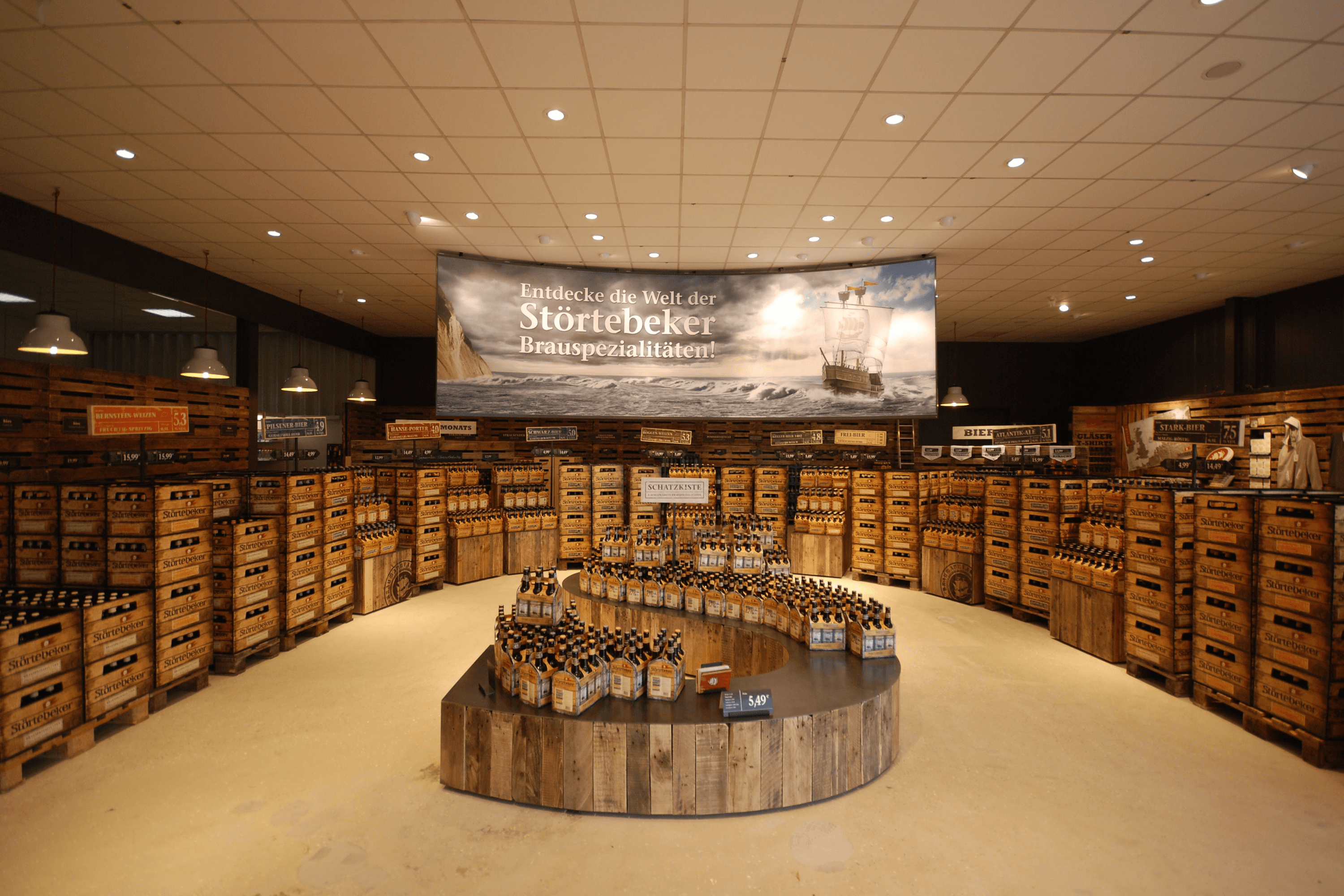 Wooden crates and bottles of beer displayed in a store.