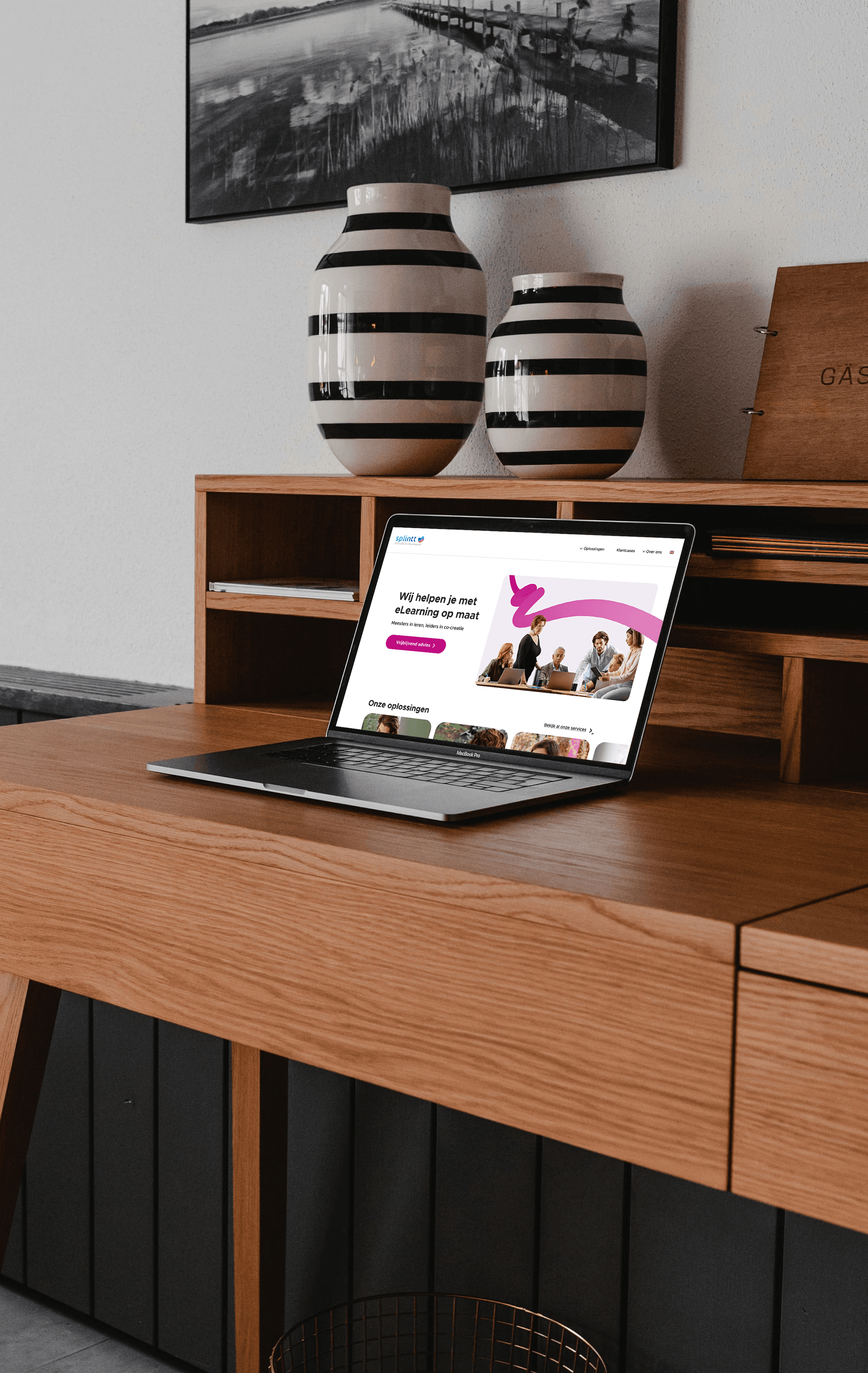 A mockup for a Macbook placed on a table for website