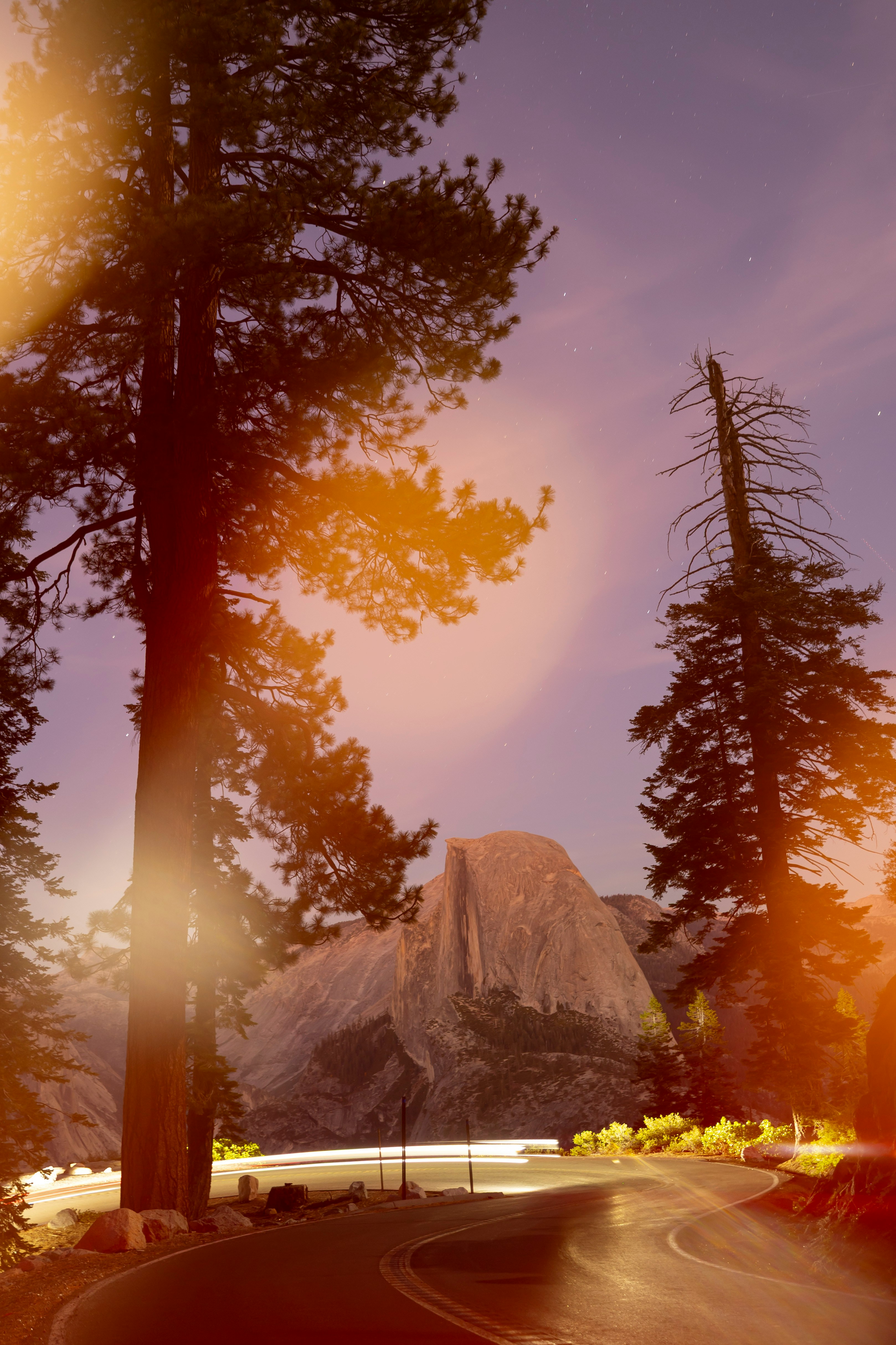 Road leading to half dome at dusk with trees