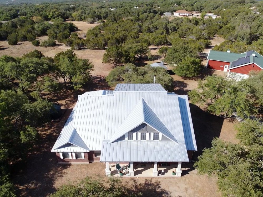 A sleek standing seam 24-gauge mill finish galvalume roof with clean lines and a durable, energy efficient reflective finish.