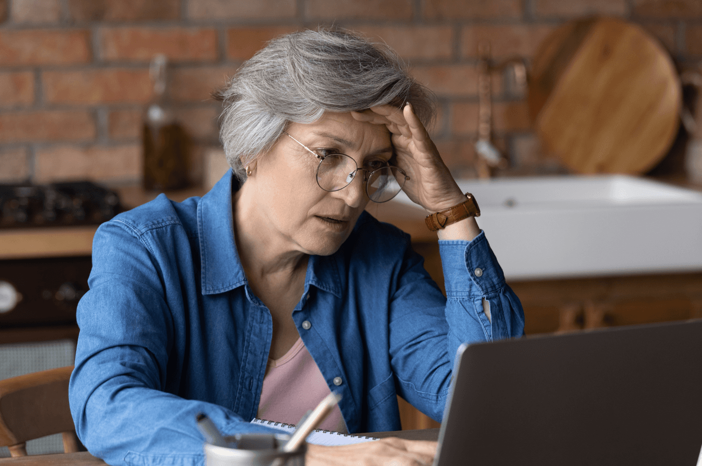 Stressed senior woman have problems working on laptop