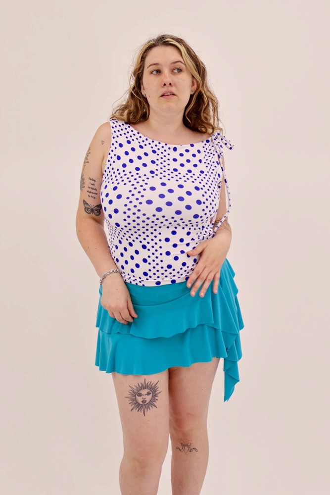 female model wearing blue polka dot top