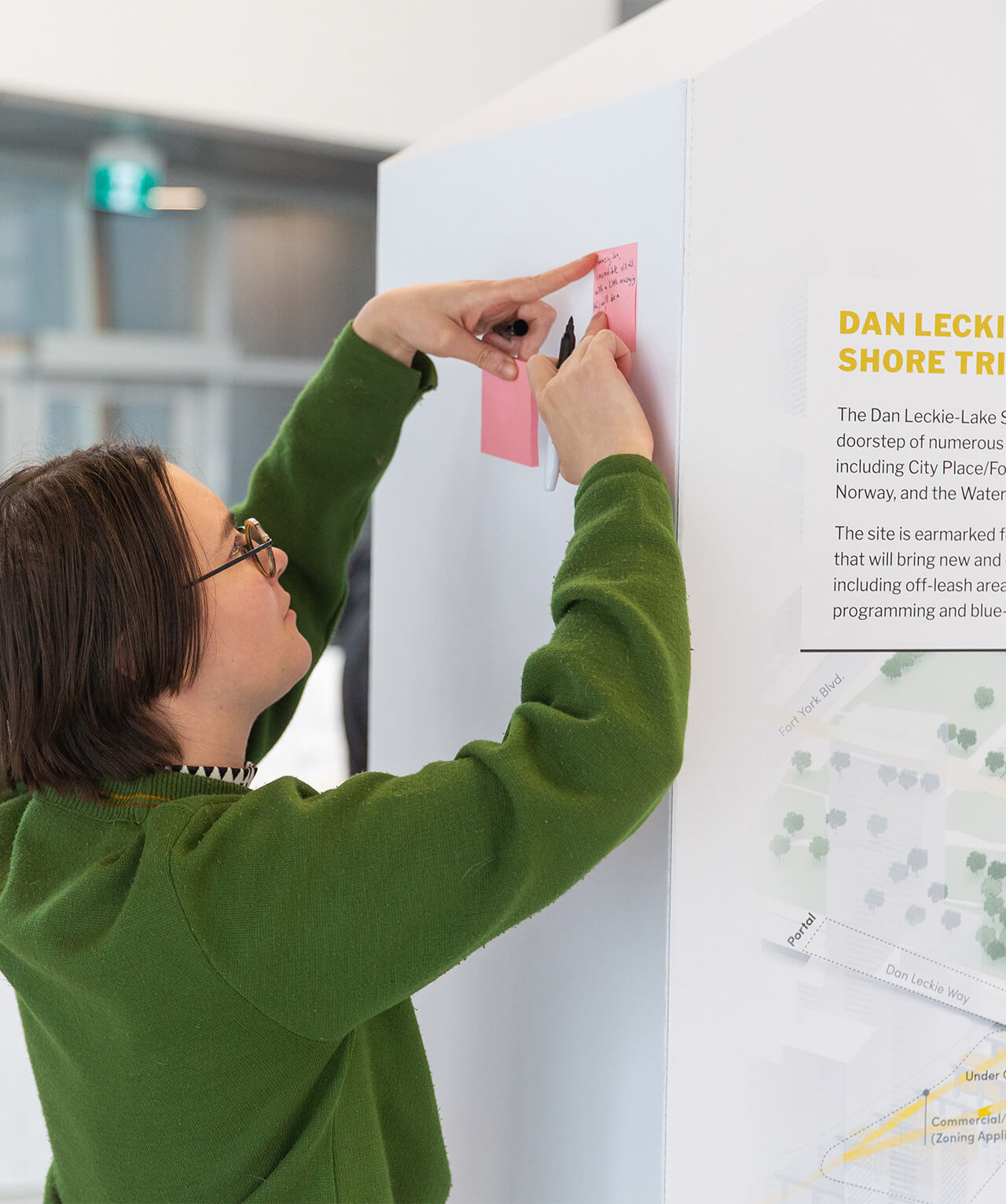 A participant writing their thoughts on a sticky note.