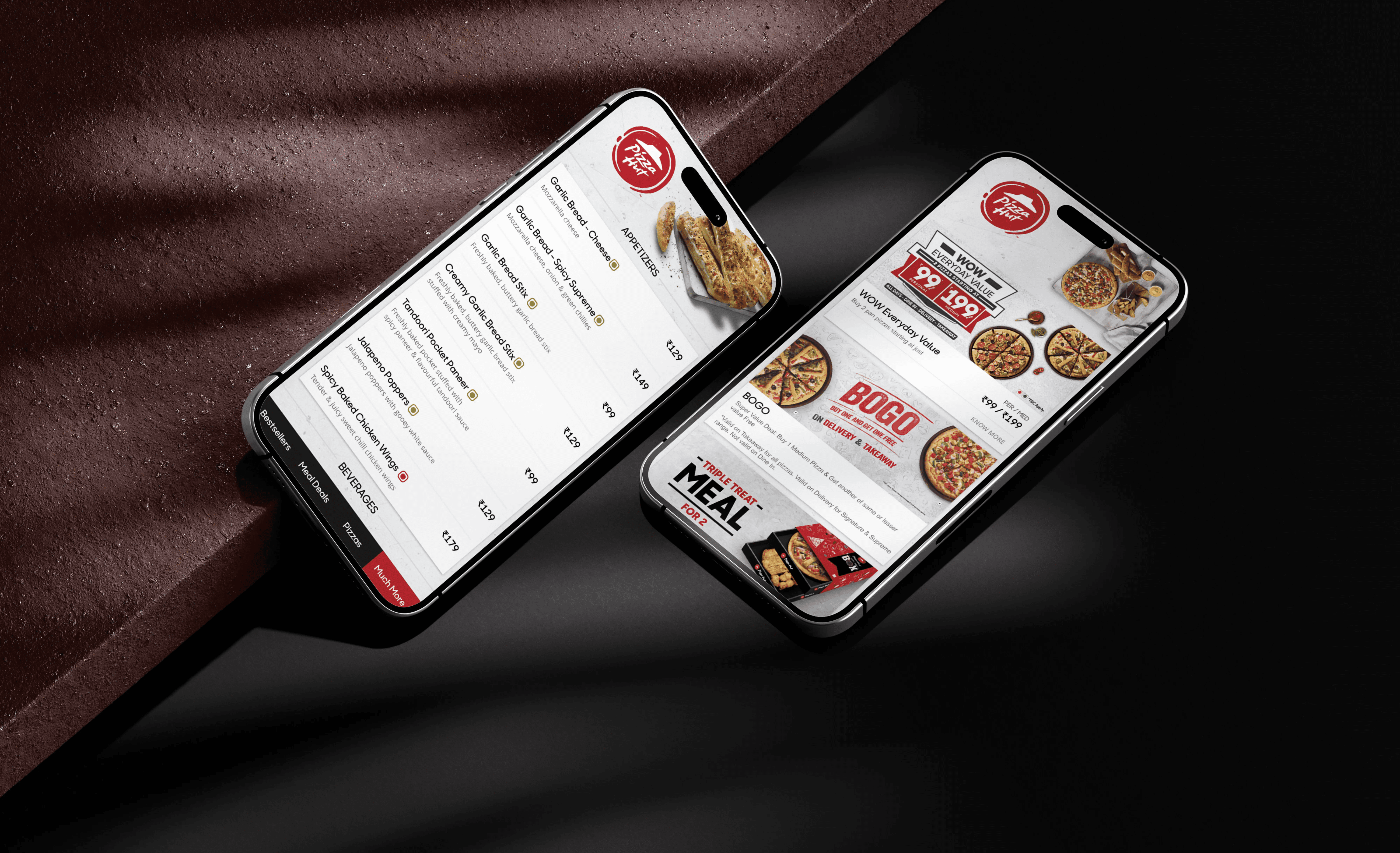 a man walking past a pizza hut at night