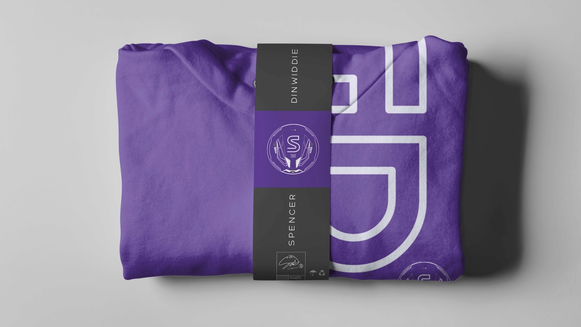 Spencer Dinwiddie SGD.26 folded purple hoodie with premium charcoal belly band packaging featuring S25 crest logo and signature details
