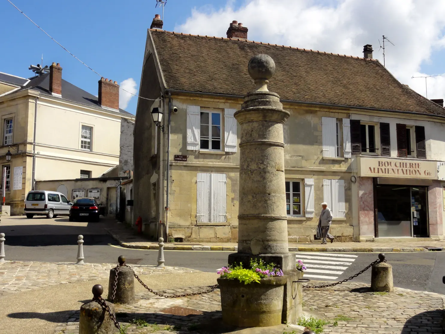 Maison en pierre et toiture en tuiles sur une place de Marines (95)