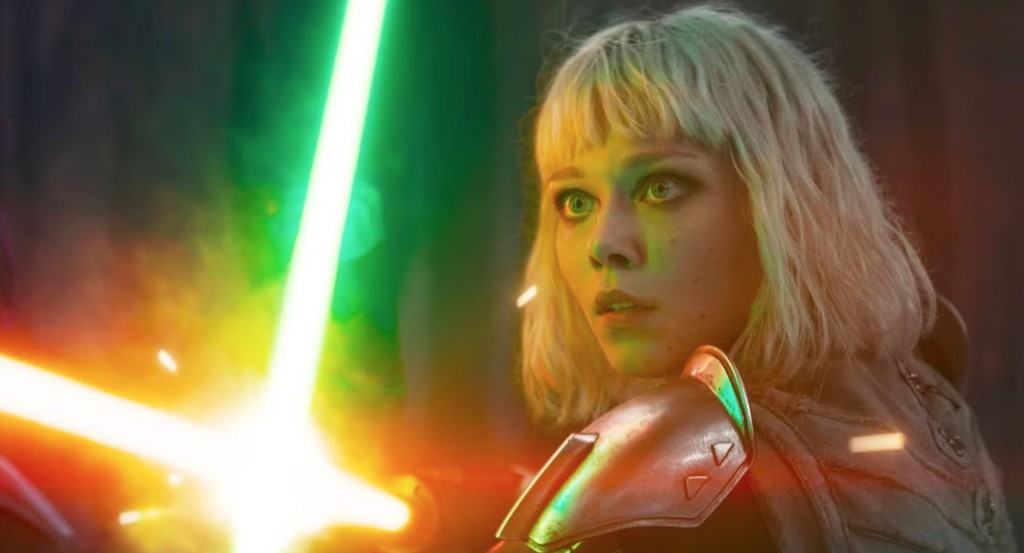 Shin Hati blocking a green lightsaber with her red lightsaber and looking shocked