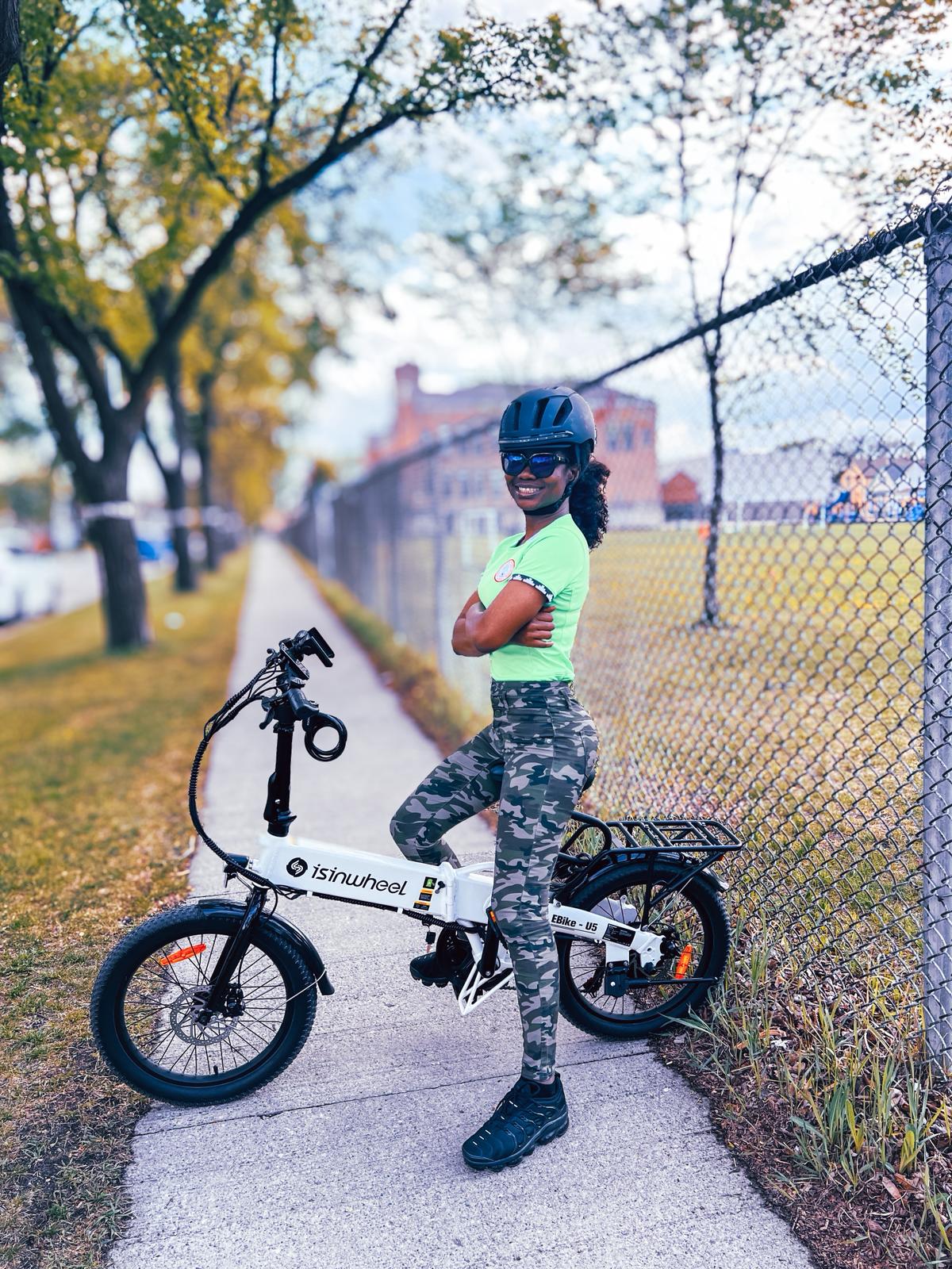 Sandra Osaretin riding a bicycle outdoors, representing a personal milestone and creative balance