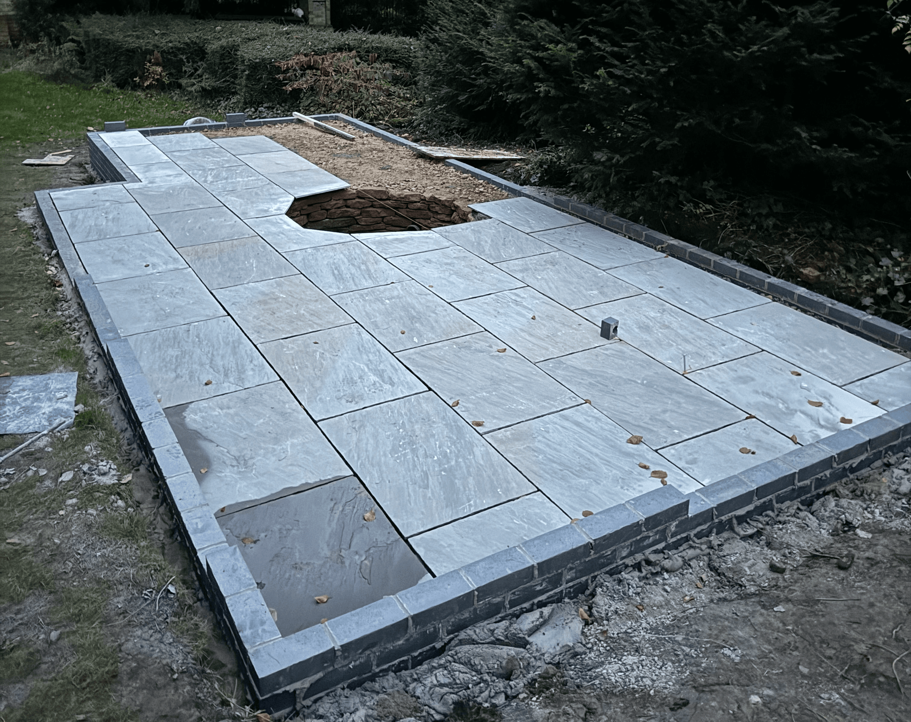 Blue brick retaining walls were built with MOT inside. Then the slabbing begun