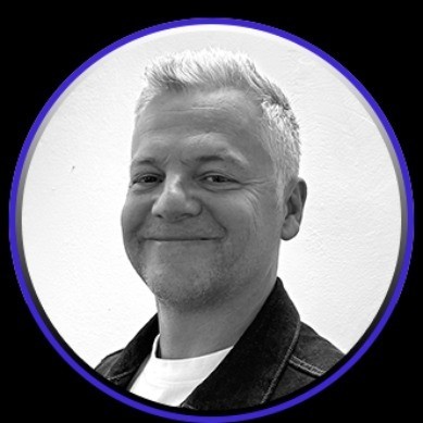 A man works on a laptop in an office.