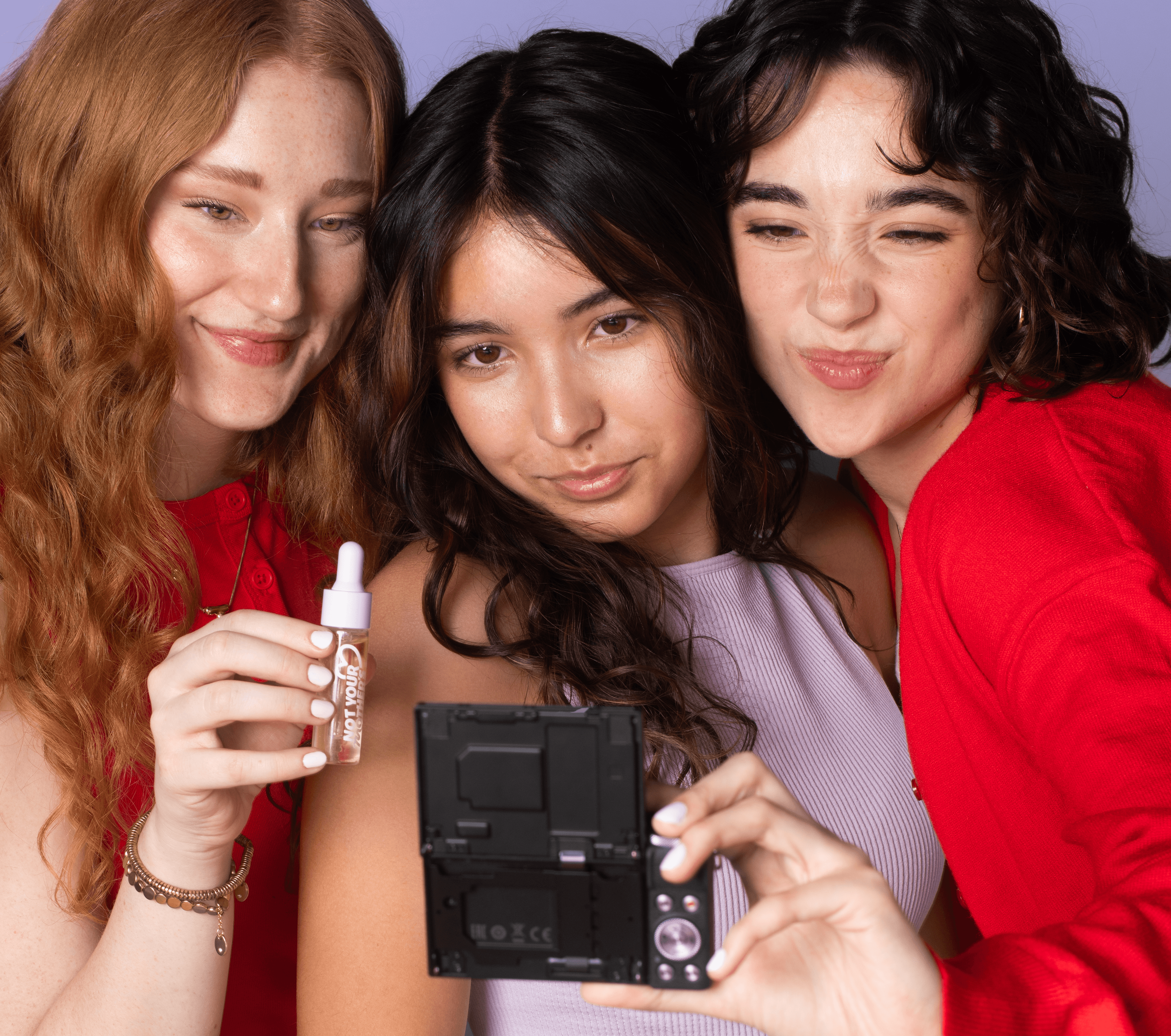 group of women taking selfie with Not Your Mother's product in hands