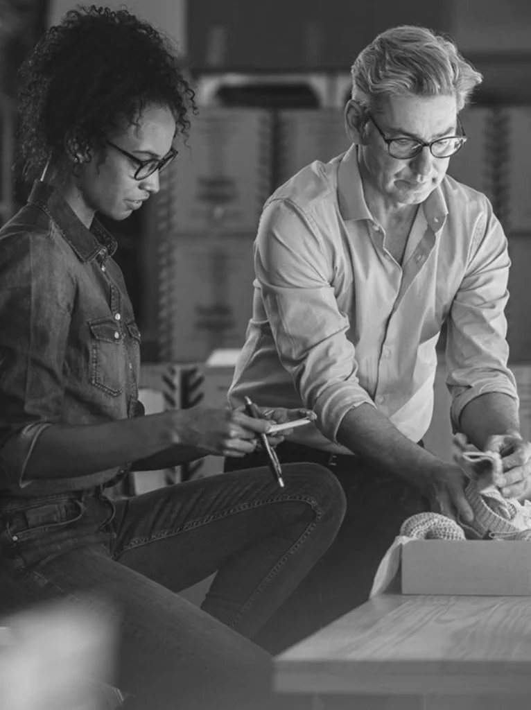 female smiling wearing a casual jacket and holding an ipad