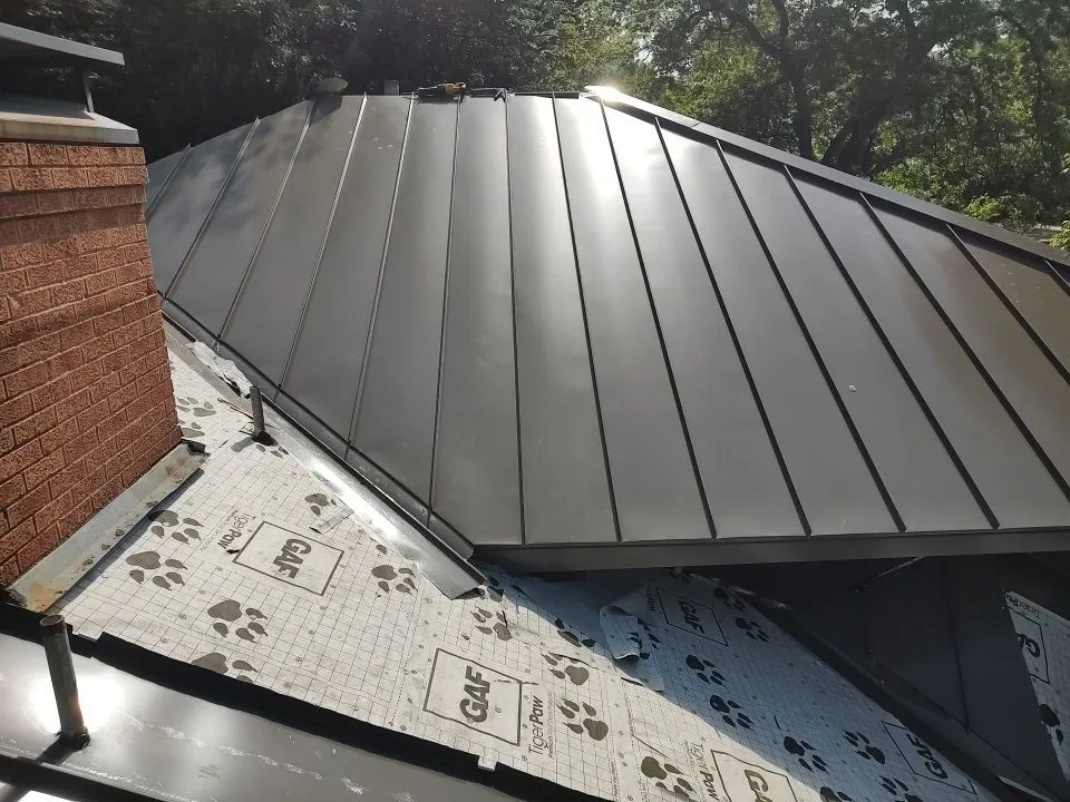 Close-up of chimney flashing and standing seam metal roof on Dallas home in East Kessler Park