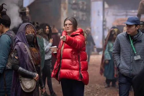 Director Leslye Headland in a red jacket giving direction to Amandla Stenberg dressed as Mae