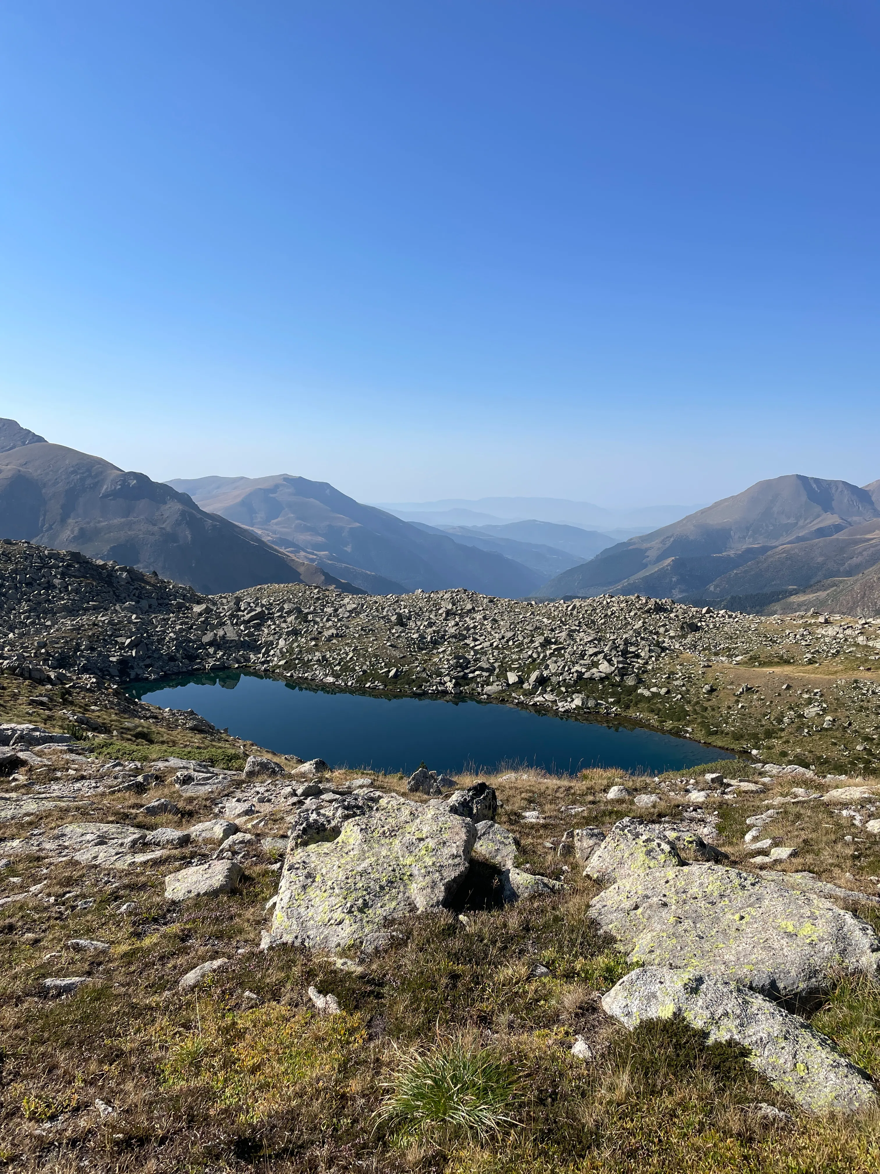 trekking in mountains with a male in the middle of the pathway