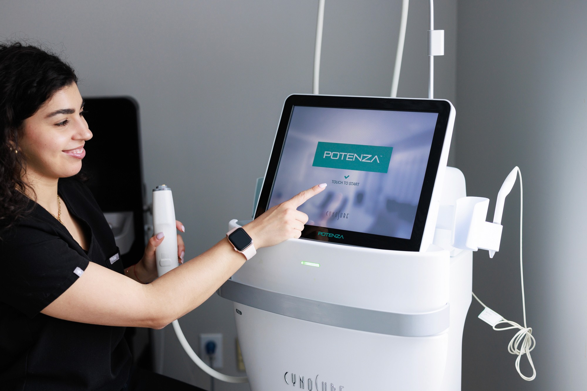 Beautician preparing the equipment for the microneedling treatment