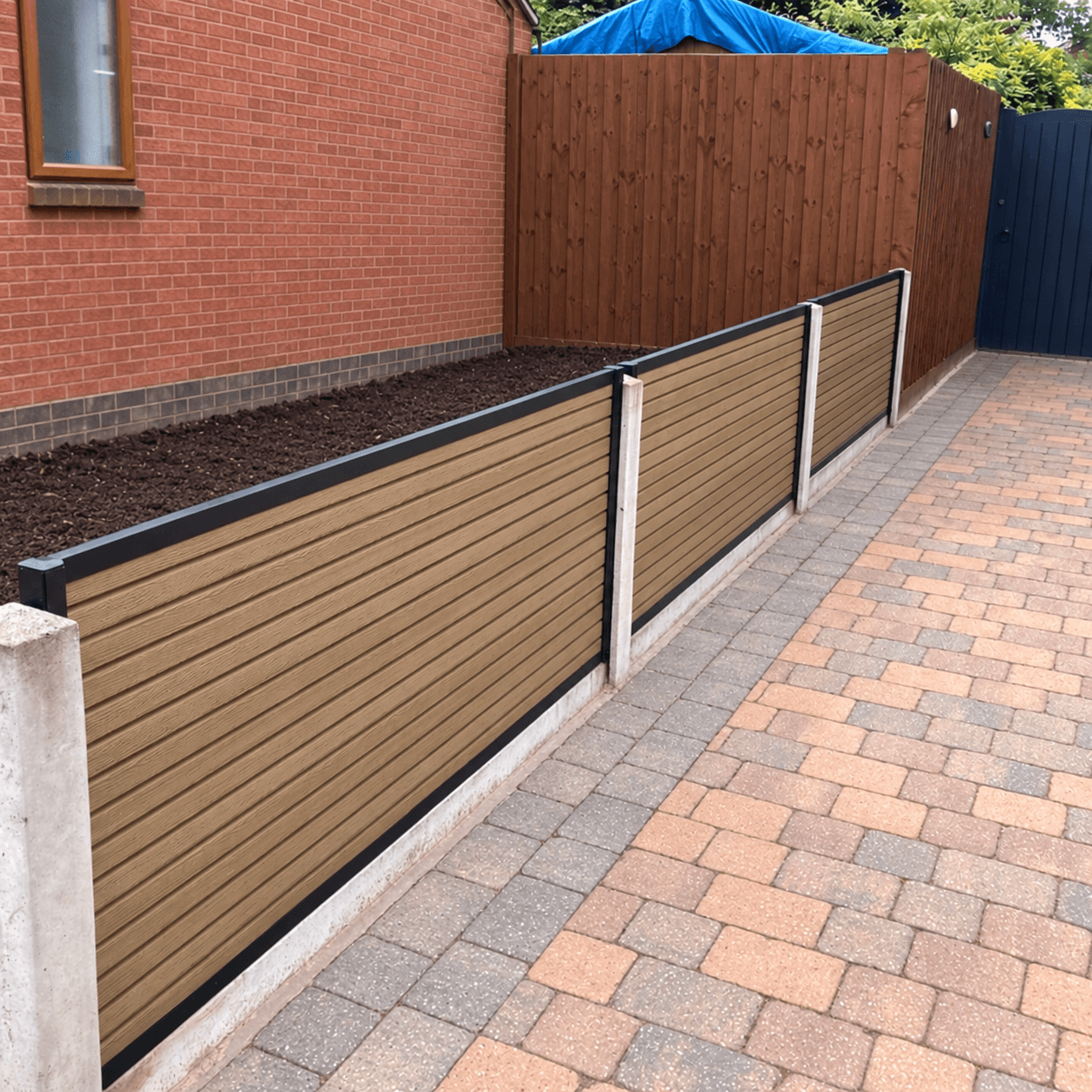 Composite fence installed with retained concrete posts
