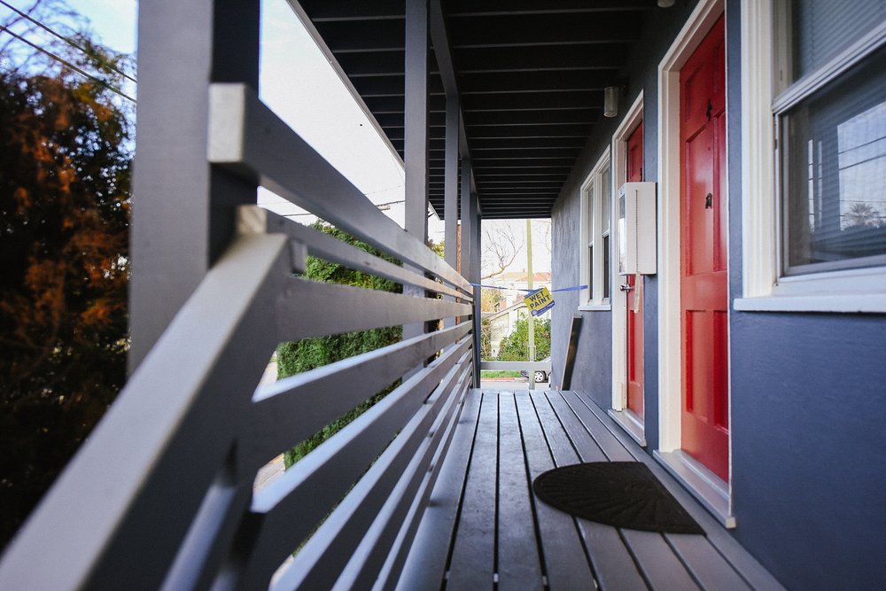 two people in a workspace working on their laptops 
