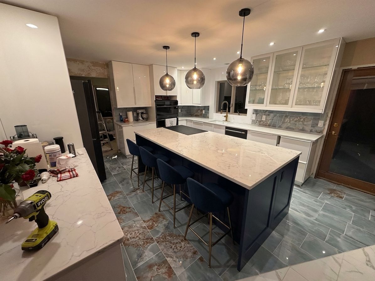 Bold contrast kitchen with navy island and smoked glass pendants