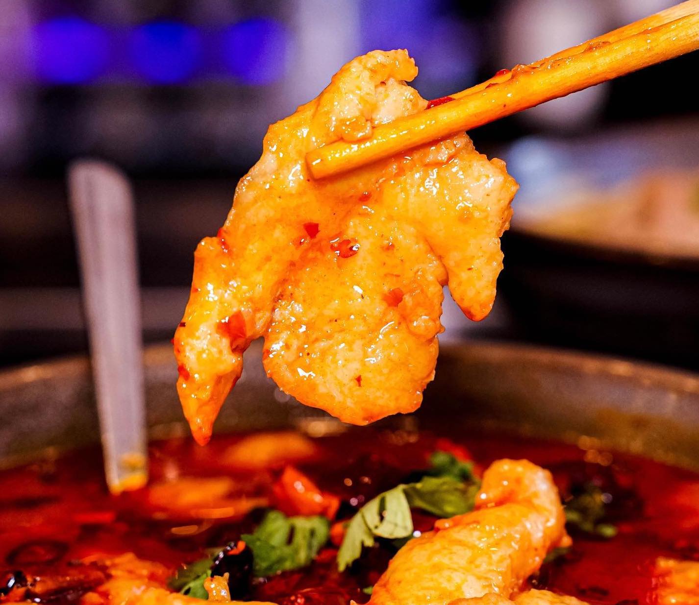 Close-up of Mala Chili Chicken at The Corner, a spicy and crunchy Sichuan-inspired dish garnished with fiery red chilies.