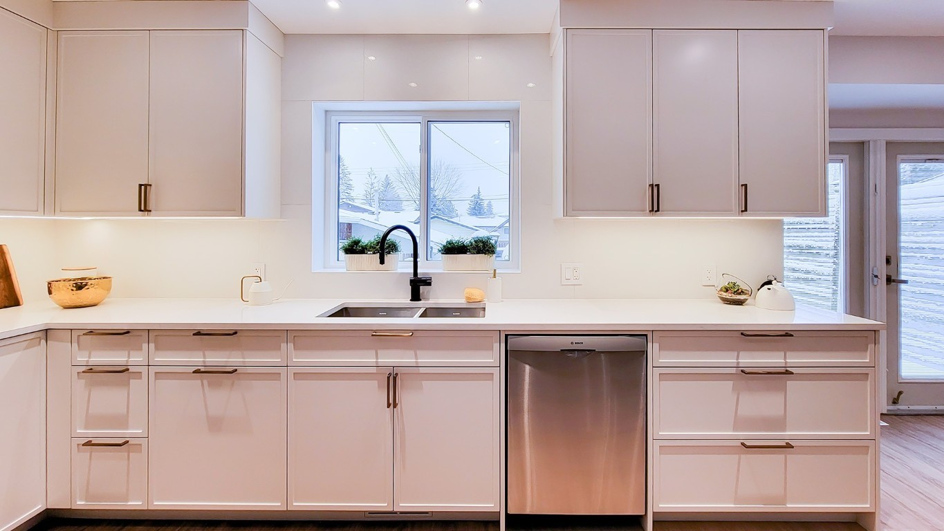 Image of Modern kitchen interior design by KHD Homes featuring white cabinets and luxurious layout design elements.