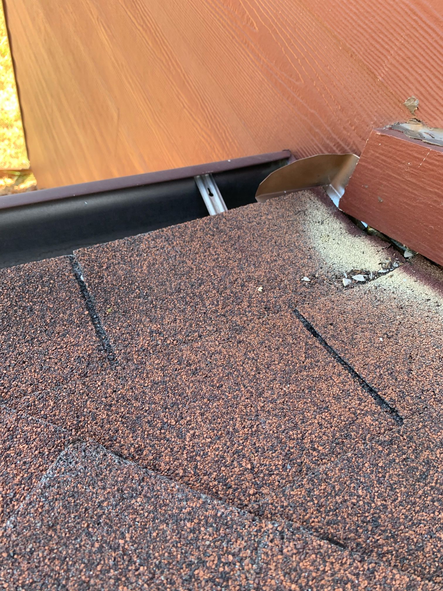 Roof-to-wall and gutter-adjacent flashing detail from a Barnes N’ Roofs repair.