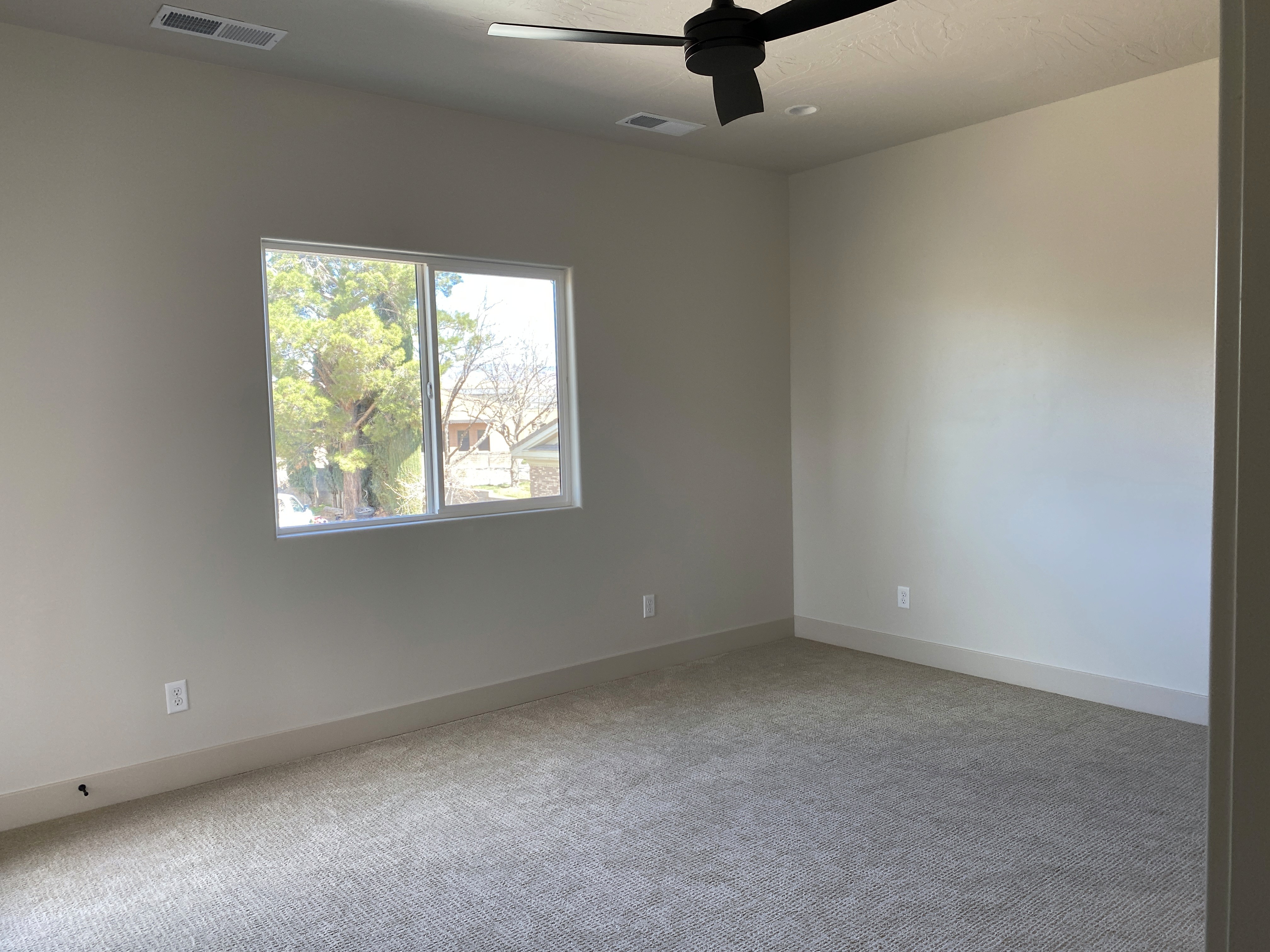 Secondary bedroom in a duplex with functional layout and simple finishes in Hurricane, Utah home.