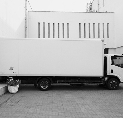 a red truck parked in front of a garage