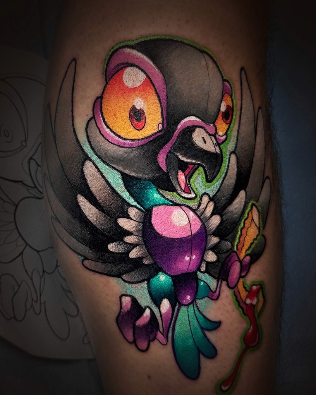 Odd Tattoos new school thigh tattoo of a cartoon owl with enormous round eyes, colorful teal and purple feathers, and a mischievous expression