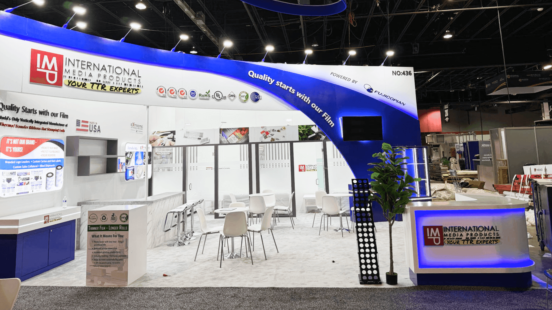 20x20 label printing trade show booth with packaging system display and workflow presentation layout