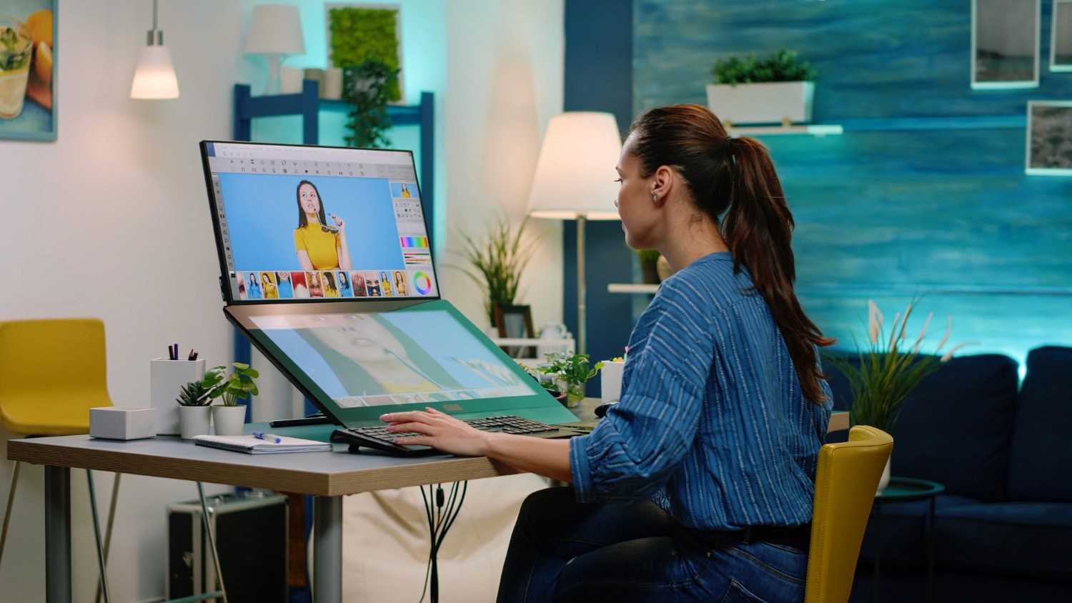 A woman working diligently at her desk with a laptop, showcasing a productive and organized environment.